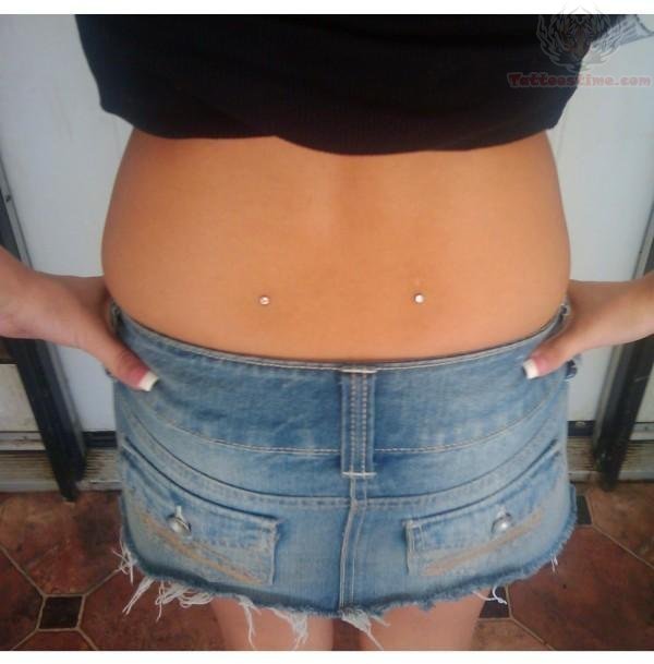 Young Girl Have Back Dimple Piercing With Dermal Anchors