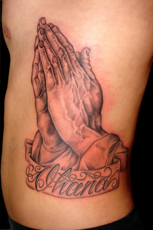 Amazing Praying Hands With Banner Tattoo On Side Rib By Andrew Sussman