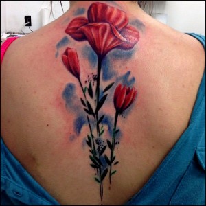 Amazing Red Three Tulip Flowers Tattoo On Girl Upper Back