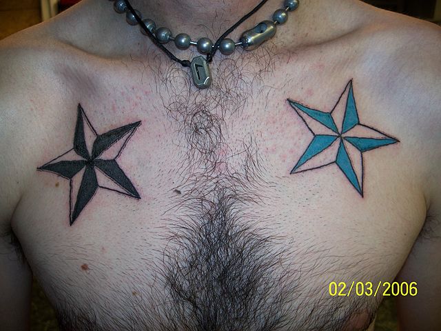 Black And Blue Two Nautical Star Tattoo On Man Chest