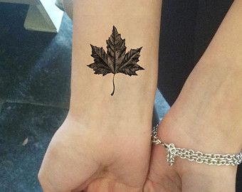 Black And Grey Maple Leaf Tattoo On Wrist