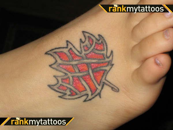 Black And Red Celtic Maple Leaf Tattoo On Foot