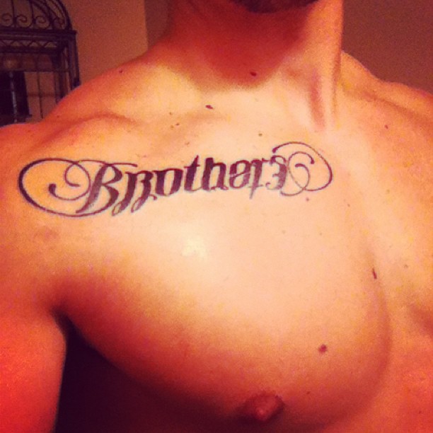 Black Brother Tattoo On Collarbone
