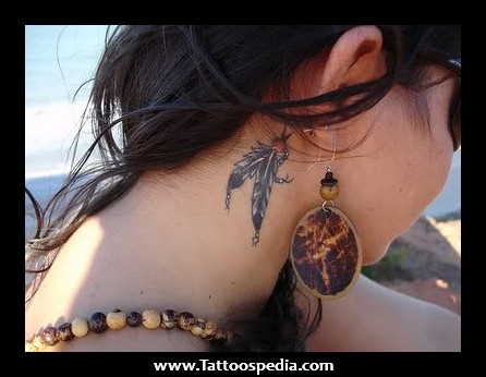 Black Ink Indian Feather Tattoo On Girl Behind The Ear