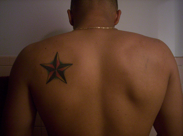 Black Nautical Star Tattoo On Left Back Shoulder