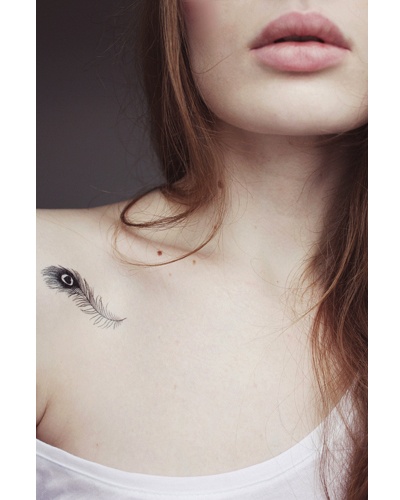 Black Peacock Feather Tattoo On Girl Collarbone