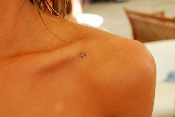 Black Tiny Star Tattoo On Girl Collarbone