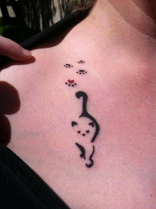 Black Tribal Cat With Paw Prints Tattoo On Collarbone