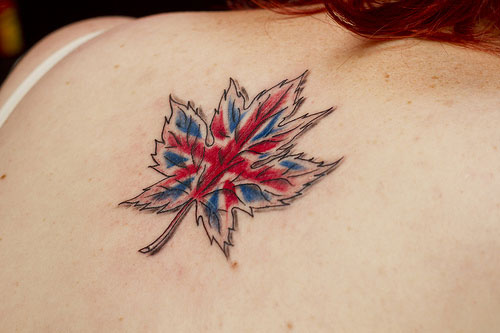 British Flag In Maple Leaf Tattoo On Girl Upper Back