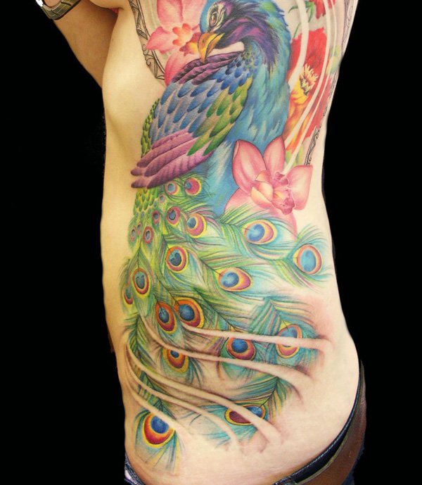 Colorful Peacock With Flowers Tattoo On Side Rib