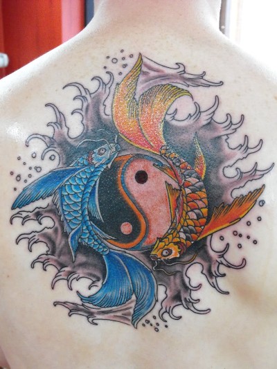 Colorful Pisces With Yin Yang Tattoo On Upper Back