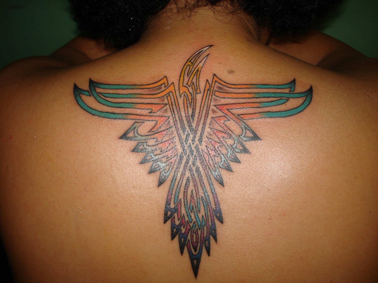 Colorful Tribal Indian Eagle Tattoo On Man Upper Back
