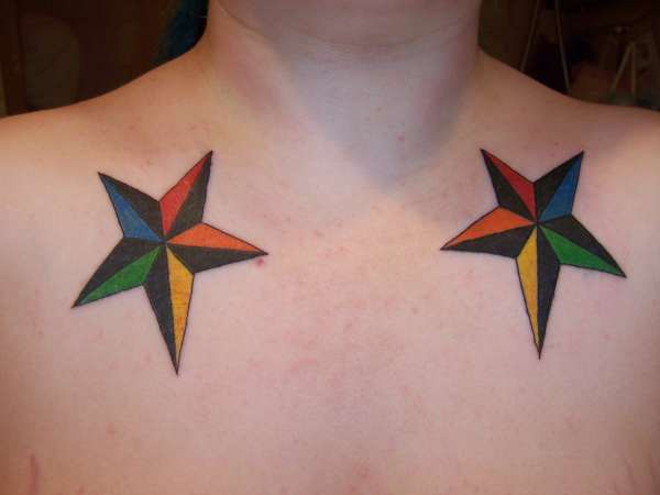 Colorful Two Nautical Star Tattoo On Man Chest