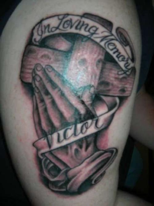 Grey Ink Praying Hands With Wooden Cross And Banner Tattoo Design