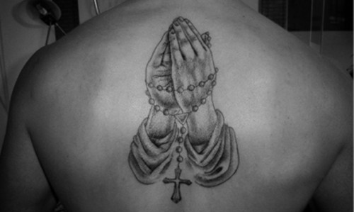Grey Ink Rosary Cross In Praying Hand Tattoo On Upper Back By Niels