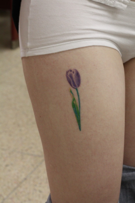 Purple Tulip Flower Tattoo On Girl Thigh