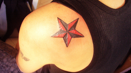 Red And Black Nautical Star Tattoo On Left Back Shoulder
