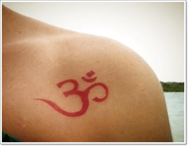 Red Om Tattoo On Collarbone