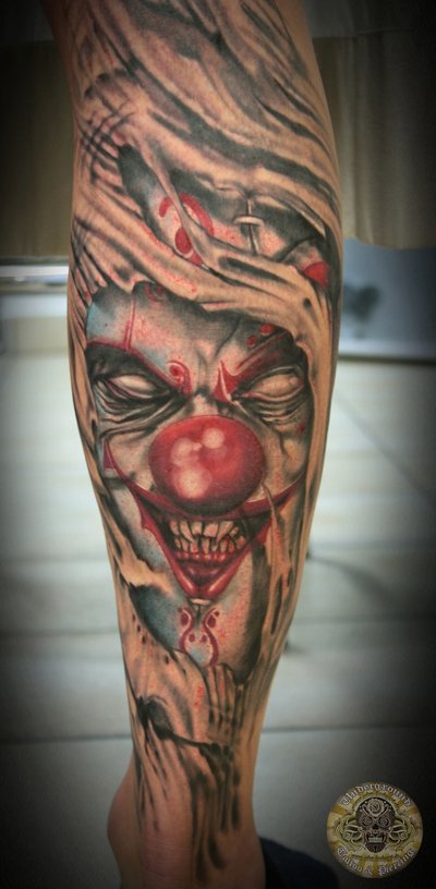 Ripped Skin Horror Clown Face Tattoo On Full Leg
