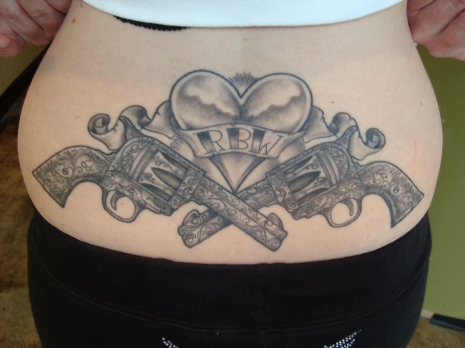 Awesome Grey Two Guns With Heart Tattoo On Lower Back