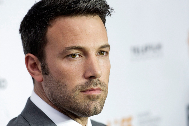 Actor and director Ben Affleck poses for a photograph on the red carpet at the gala for the new movie "Argo" during the 37th annual Toronto International Film Festival in Toronto on Friday, Sept. 7, 2012. (AP Photo/The Canadian Press, Nathan Denette)