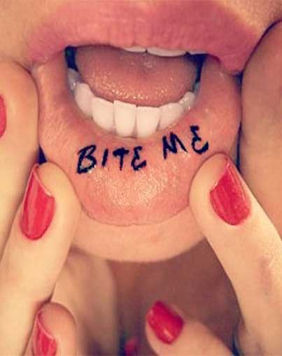 Bite Me Lettering Tattoo On Girl Inner Lip