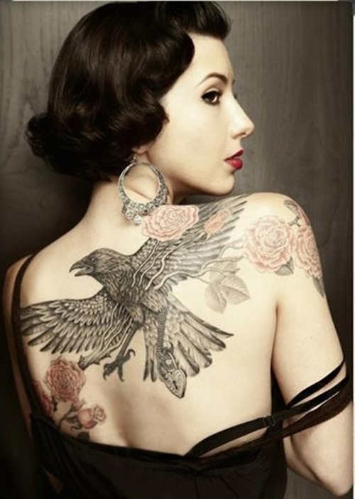 Black And Grey Flying Raven Tattoo On Women Upper Back