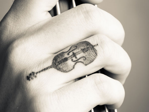 Black And Grey Little Guitar Tattoo On Finger
