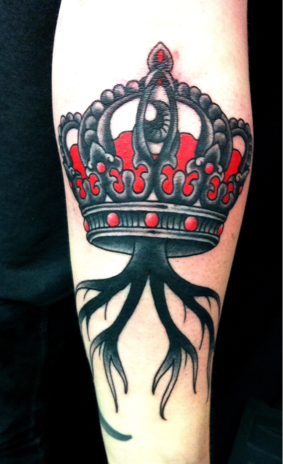 Black And Red Eye In Crown Tattoo On Forearm