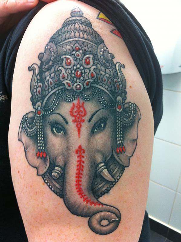 Black And Red Ganesha Head Tattoo On Shoulder