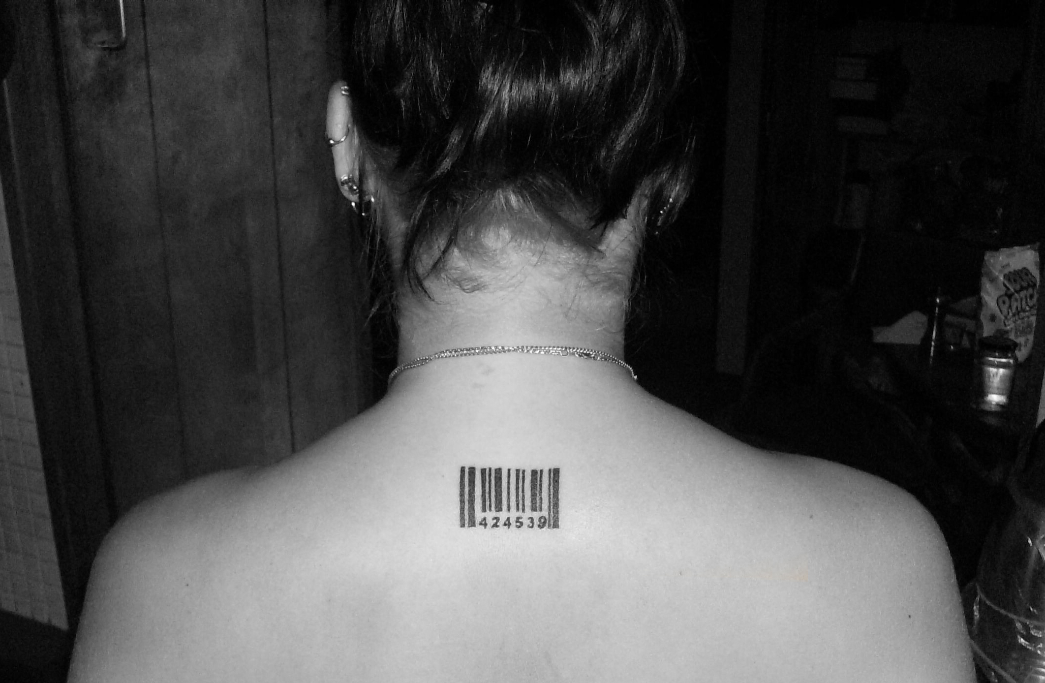 Black Barcode Tattoo On Girl Upper Back
