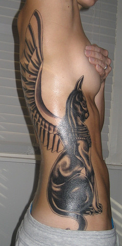 Black Bastet With Wings Tattoo On Girl Side Rib