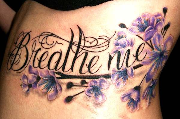 Black Breathe Me Lettering With Flowers Tattoo Design