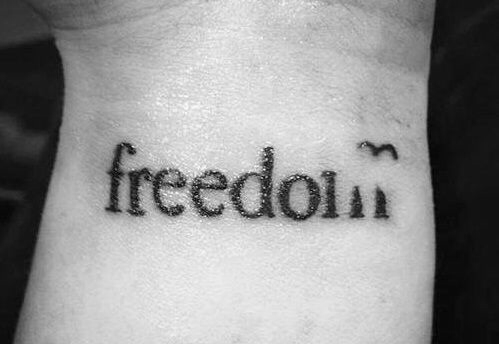 Black Freedom Lettering Tattoo On Wrist