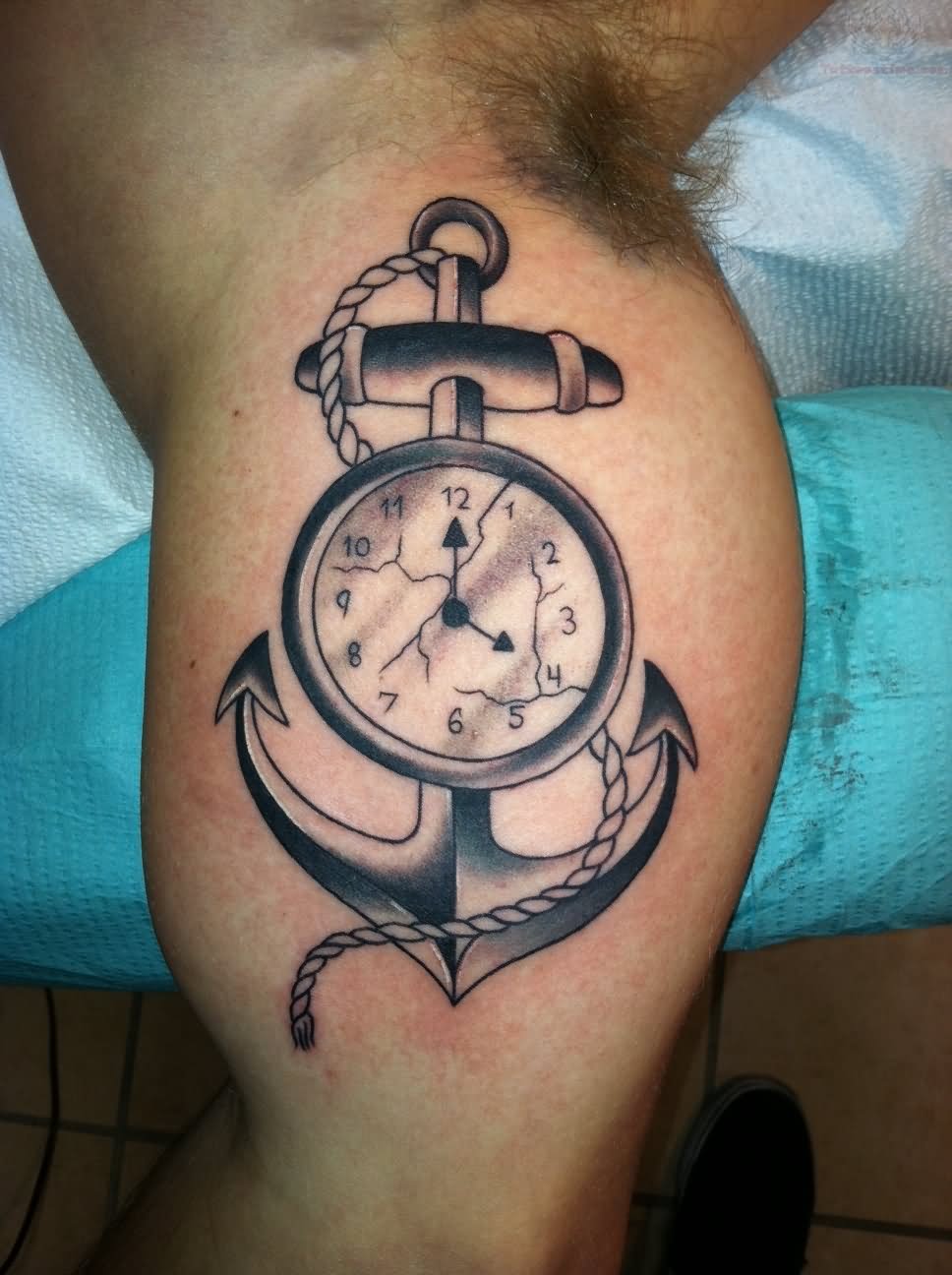 Black Ink Clock With Anchor Tattoo On Bicep