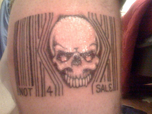 Black Ink Skull In Barcode Tattoo Design