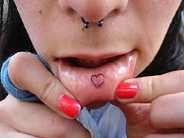 Black Outline Heart Tattoo On Girl Inner Lip