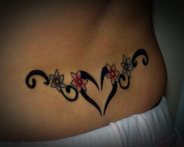 Black Tribal Heart With Flowers Tattoo on Lower Back