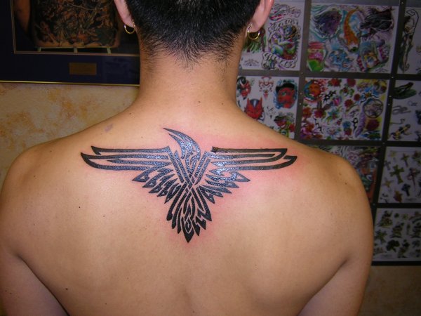 Black Tribal Raven Tattoo On Man Upper Back