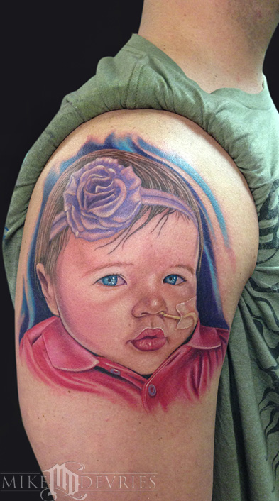 Colorful Baby Face Tattoo On Man Right Shoulder