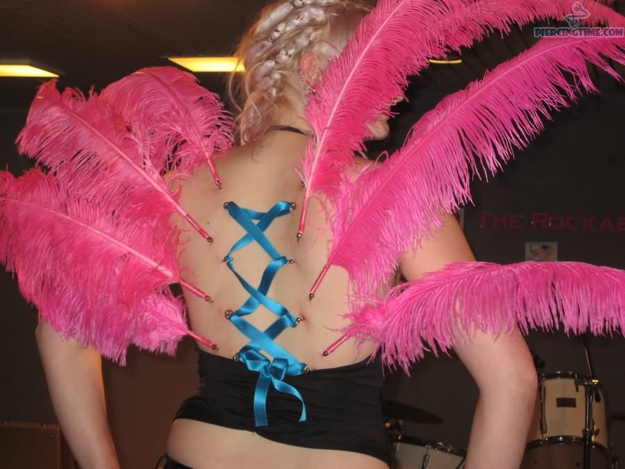 Corset And Beautiful Feather Piercing On Girl Back