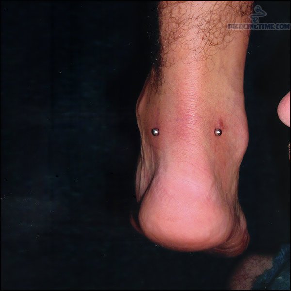 Corset Back Leg Piercing With Black Barbell