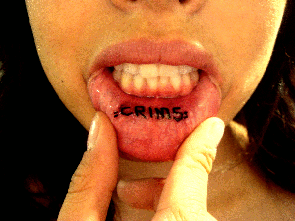 Crims Lettering Tattoo On Girl Inner Lip