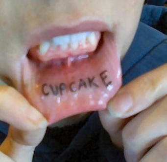 Cupcake Lettering Tattoo On Inner Lip