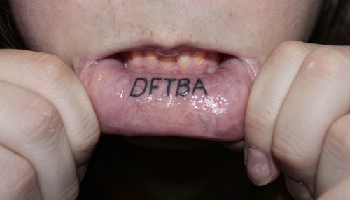 Dftba Lettering Tattoo On Inner Lip