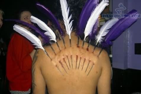 Extreme Feather Piercing On Upper Back With Purple And White Feathers