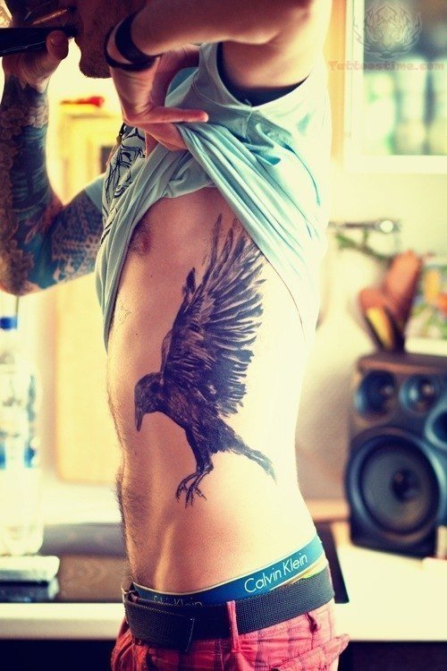 Flying Raven Tattoo On Man Side Rib