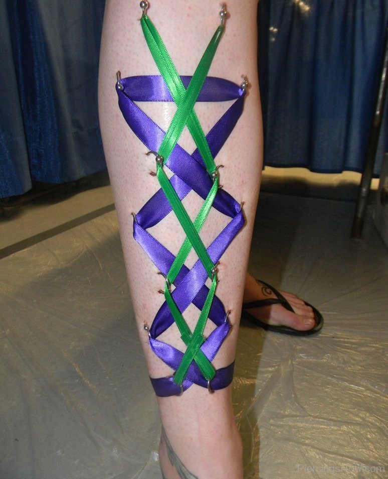 Green And Blue Ribbon Corset Piercing On Leg