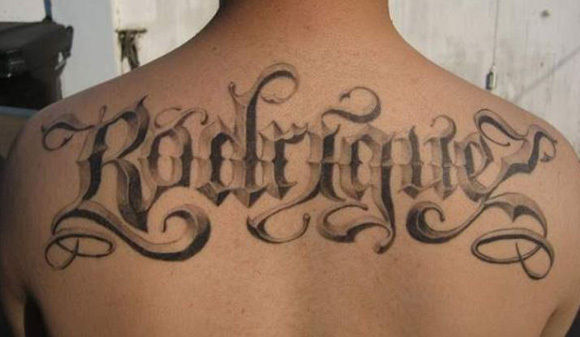 Grey Ink 3D Rodridge Lettering Tattoo On Upper Back