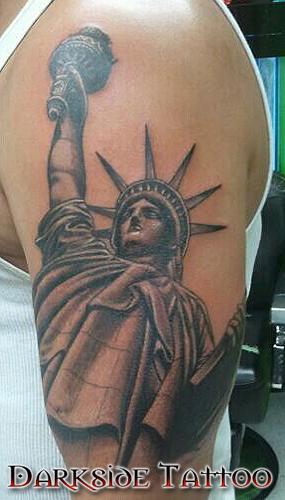 Grey Ink 3D Statue Of Liberty Tattoo On Shoulder